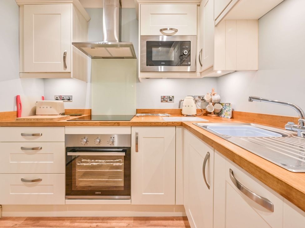 A kitchen with a sink and appliances at Muntham - Studio Apartment 7 Torquay