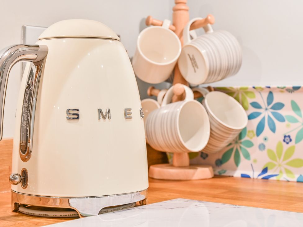 A kettle and cups on a kitchen counter at Muntham - Studio Apartment 7 in Torquay