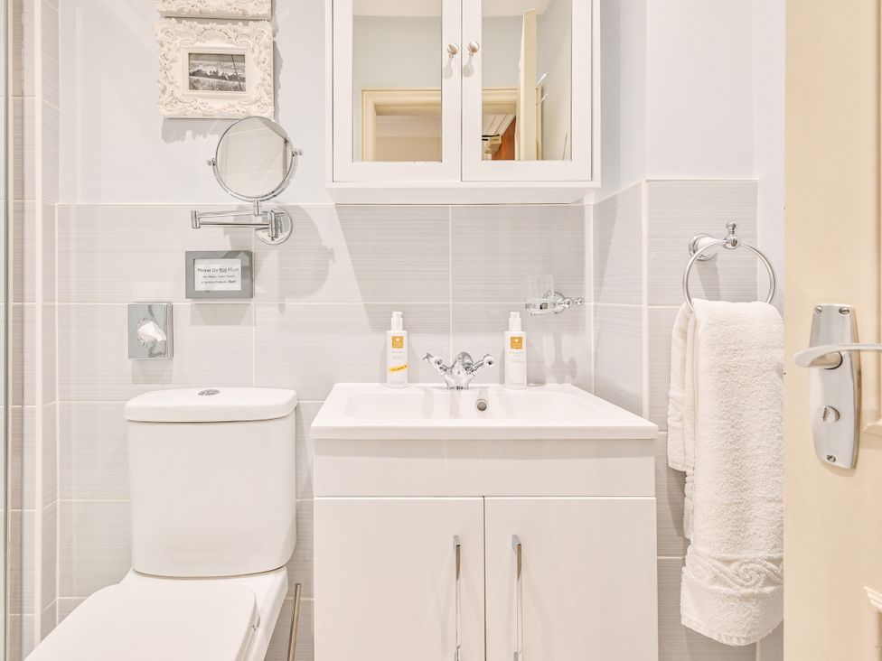 A bathroom with a sink and toilet at Muntham - Studio Apartment 7 in Torquay