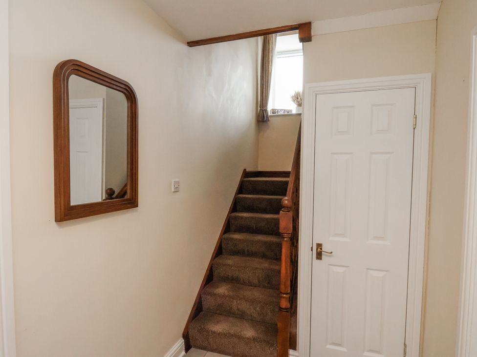 A staircase leading to the upper floor in Starlight Cottage