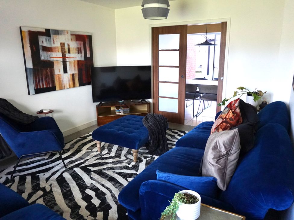 A living room with a sofa and television at the property