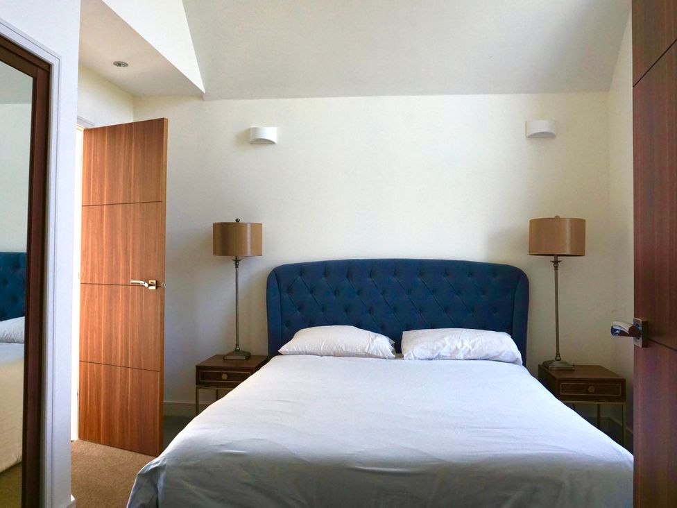 A bedroom with a bed and bedside tables at The Old Barn in Manchester