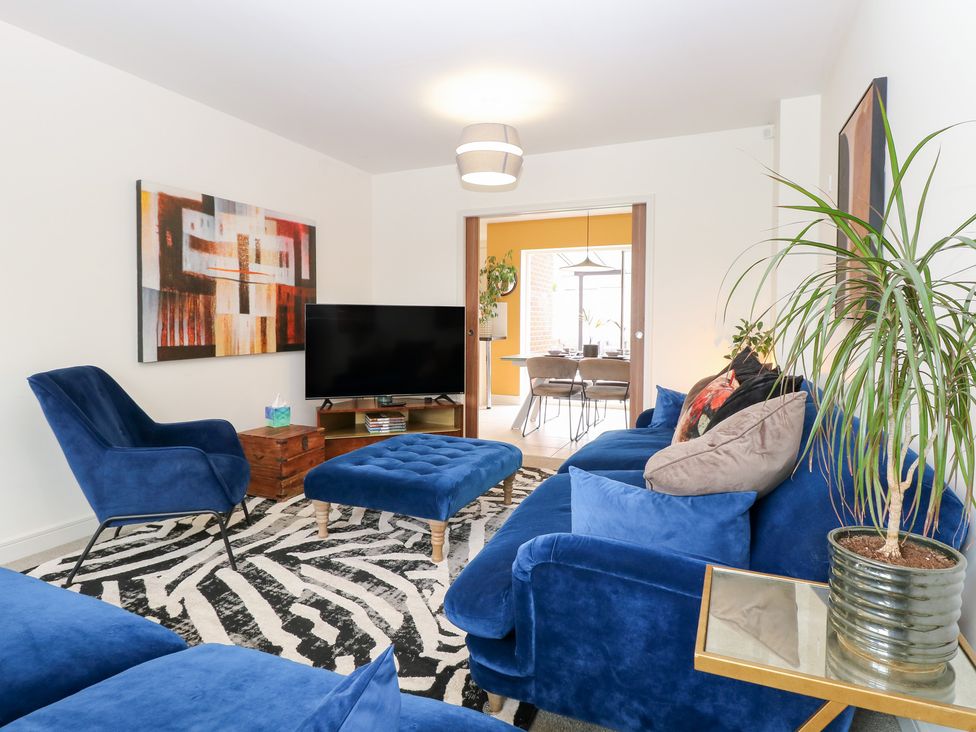 A living room with a sofa and television at Manor Park View Norwich