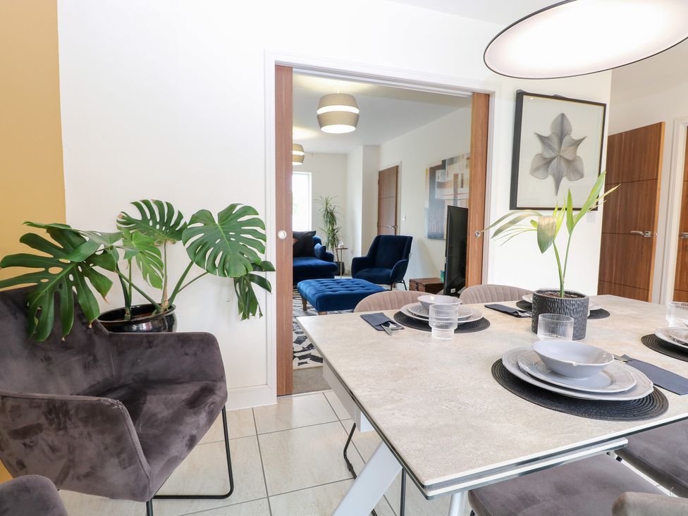 A dining room with a table and chairs at Manor Park View Norwich