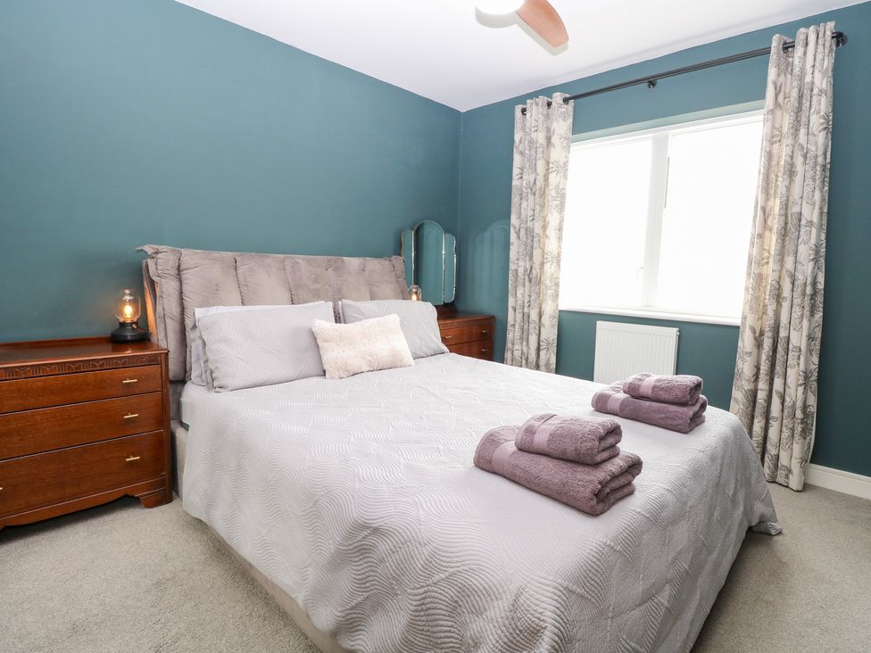 A bedroom with a bed and dresser at Manor Park View in Norwich