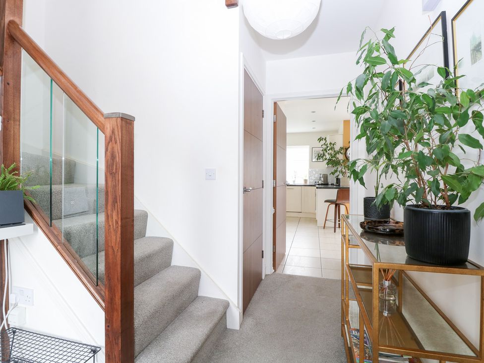 A hallway with a staircase and a table at Manor Park View in Norwich