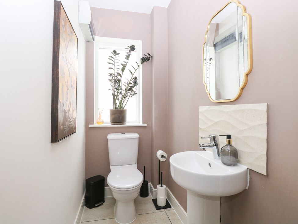 A bathroom with a toilet and a sink at Manor Park View in Norwich