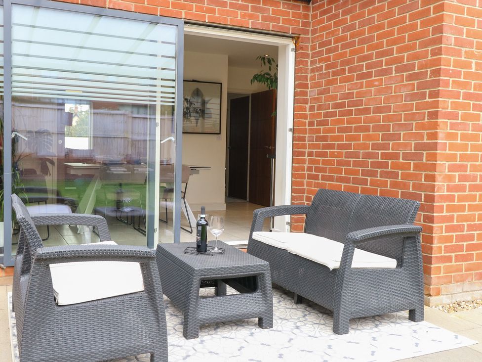 A seating area with a table and chairs at Manor Park View in Norwich