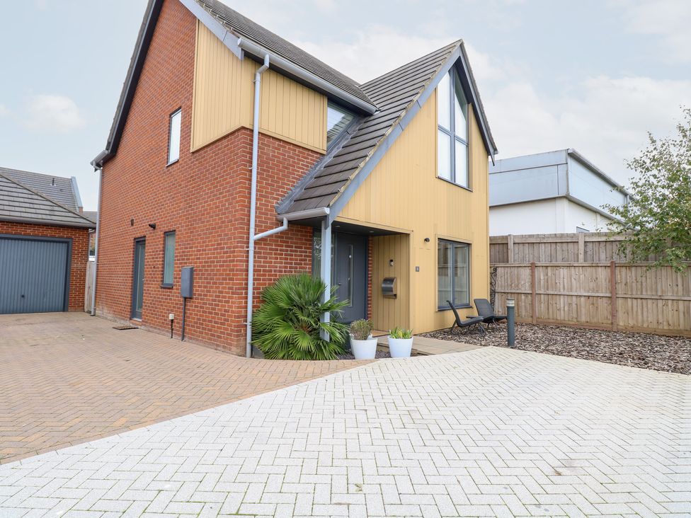 A house with a garage and pathway at Manor Park View in Norwich