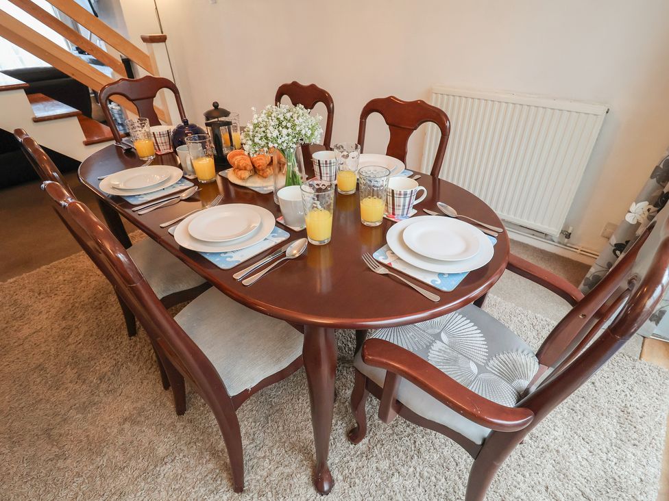 A dining table set with plates and drinks at Cromer Holiday Home in Cromer