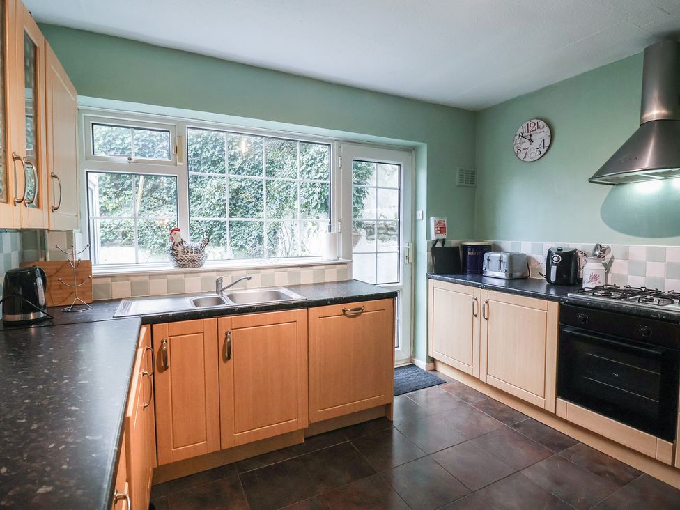 A kitchen with cabinets and appliances at Cromer Holiday Home in Cromer