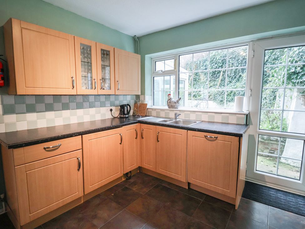 A kitchen with cabinets and a sink at Cromer Holiday Home in Cromer