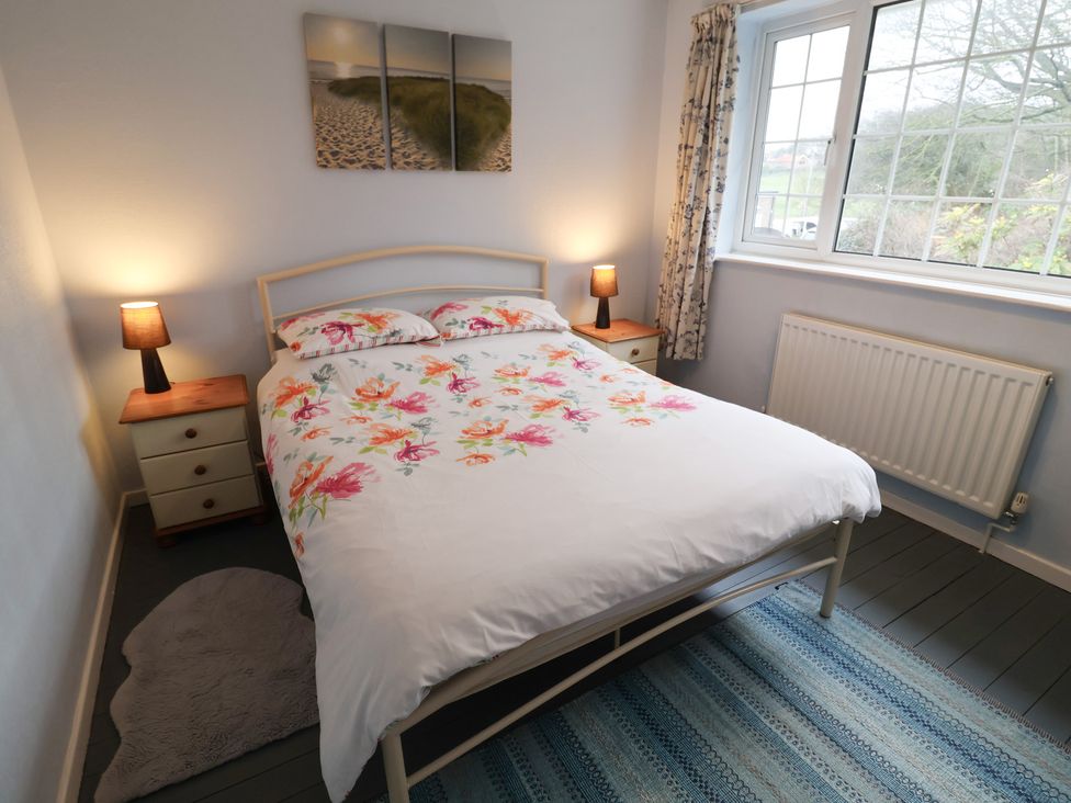 A bedroom with a bed and bedside tables at Cromer Holiday Home in Cromer