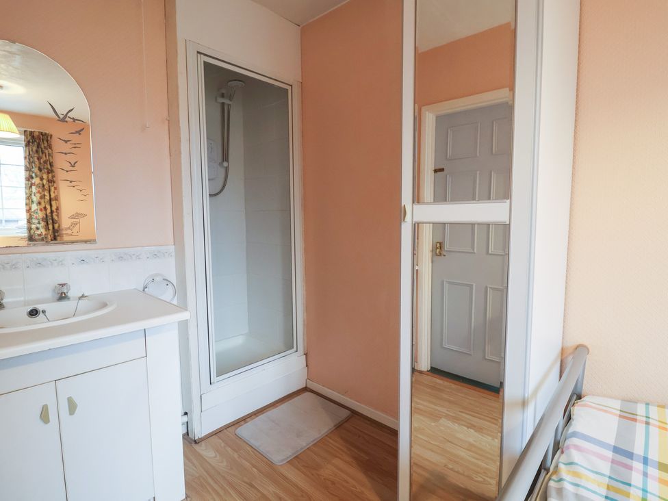 A bathroom with a shower and sink at Cromer Holiday Home in Cromer