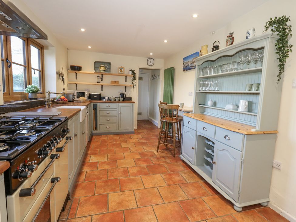 A kitchen with a stove and cabinet at Honeysuckle Cottage in Smallridge Nr. Axminster