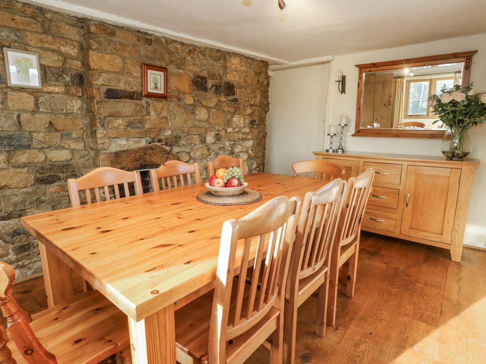 A dining room with a table and chairs at Honeysuckle Cottage Smallridge Nr. Axminster