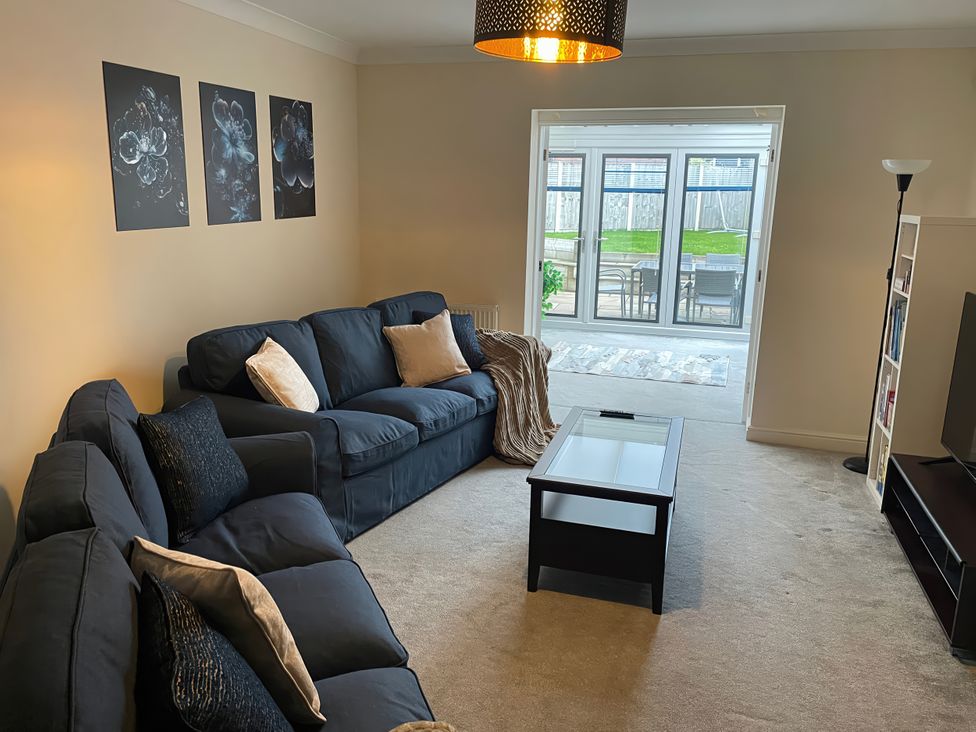 A living room with a sofa and coffee table at 1 Oldridge Crescent in Stockport