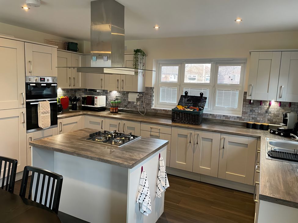 A kitchen with a gas stove and cabinets at 1 Oldridge Crescent Stockport