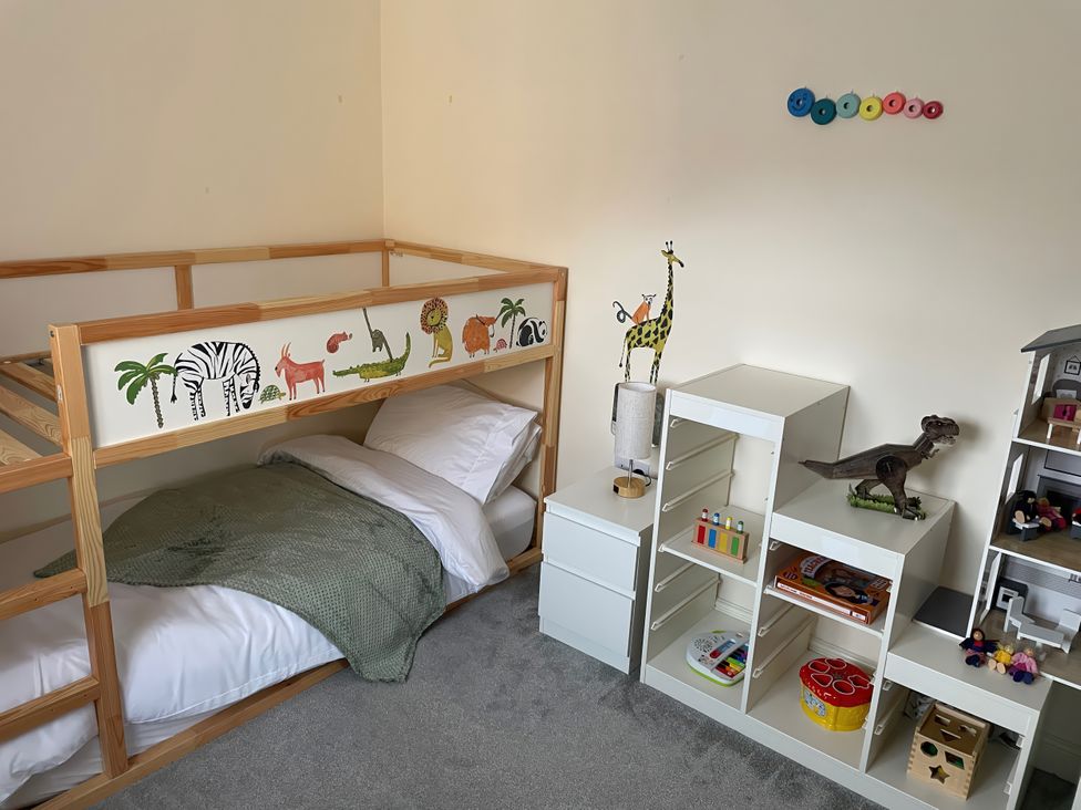A child's bedroom with a bunk bed and storage unit at 1 Oldridge Crescent Stockport