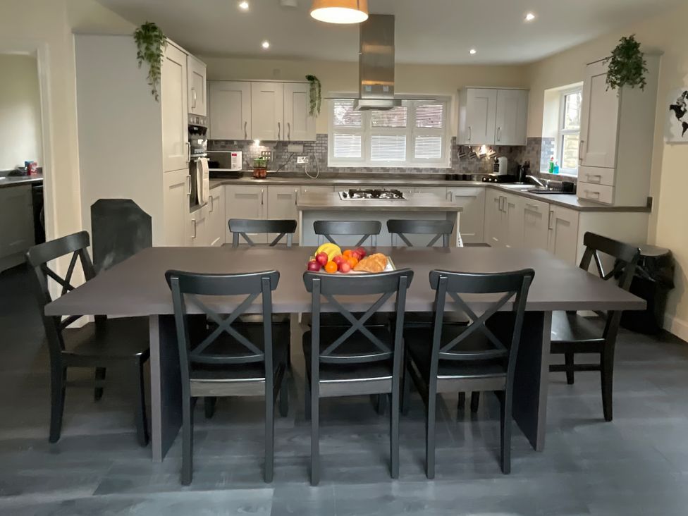 A kitchen with a dining table and chairs at The Winster in Marple, Stockport