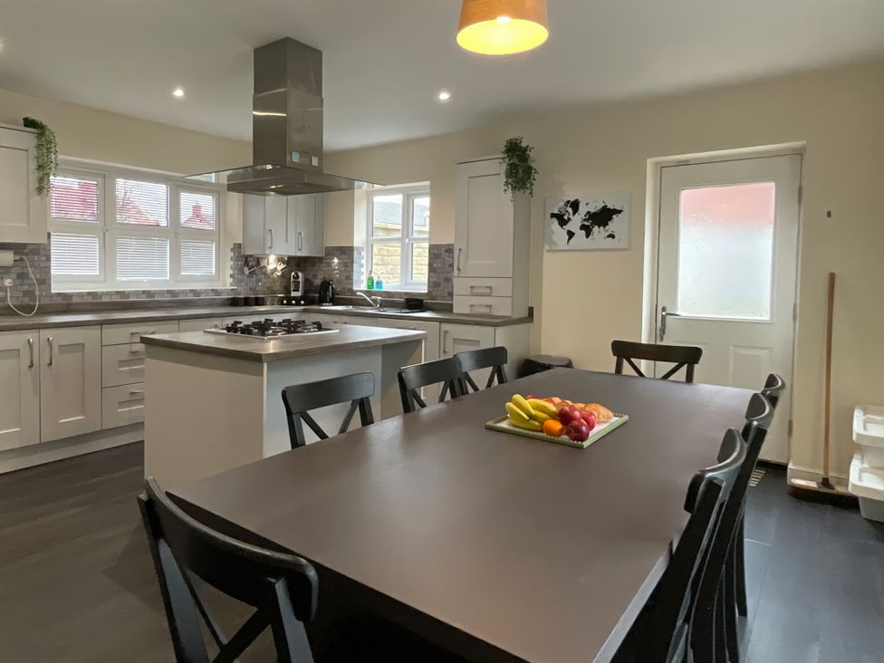 A kitchen with a dining table and chairs at The Winster in Marple, Stockport
