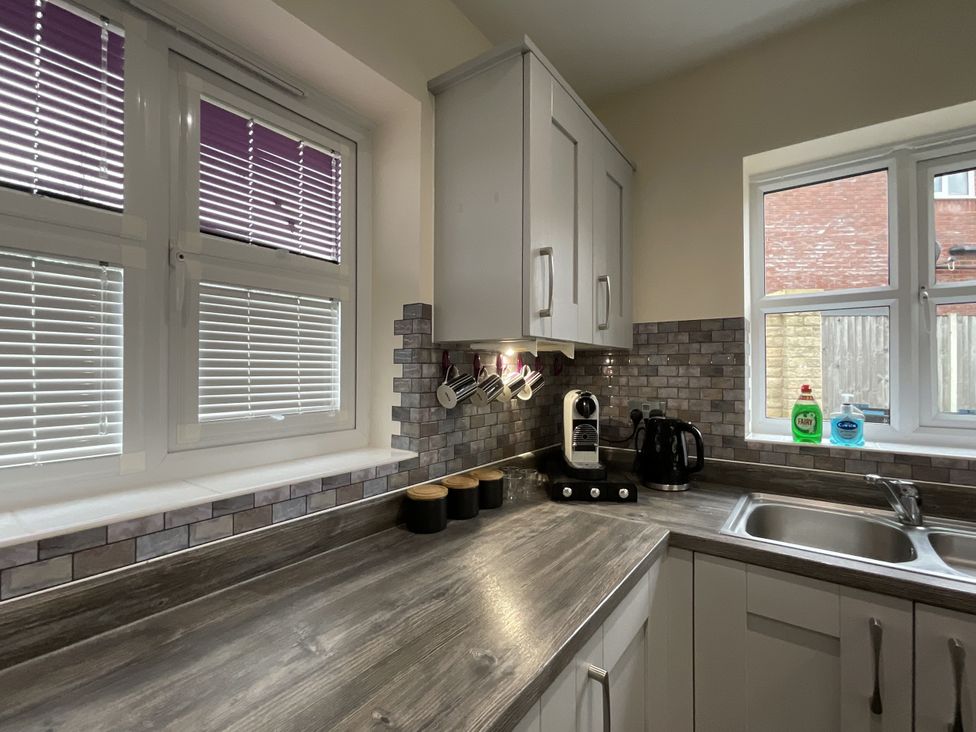 A kitchen with a sink and coffee machine at The Winster in Marple, Stockport