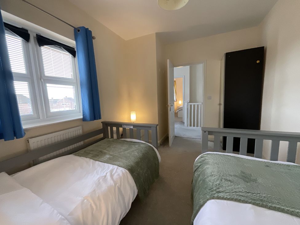 A bedroom with two beds and a window at The Winster in Marple, Stockport