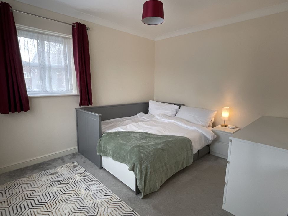 A bedroom with a bed and bedside table at The Winster in Marple, Stockport