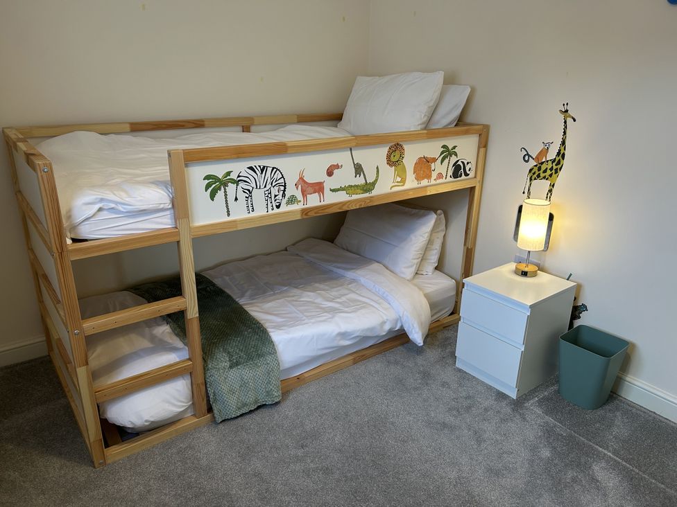 A bedroom with a bunk bed and a lamp at The Winster in Marple, Stockport