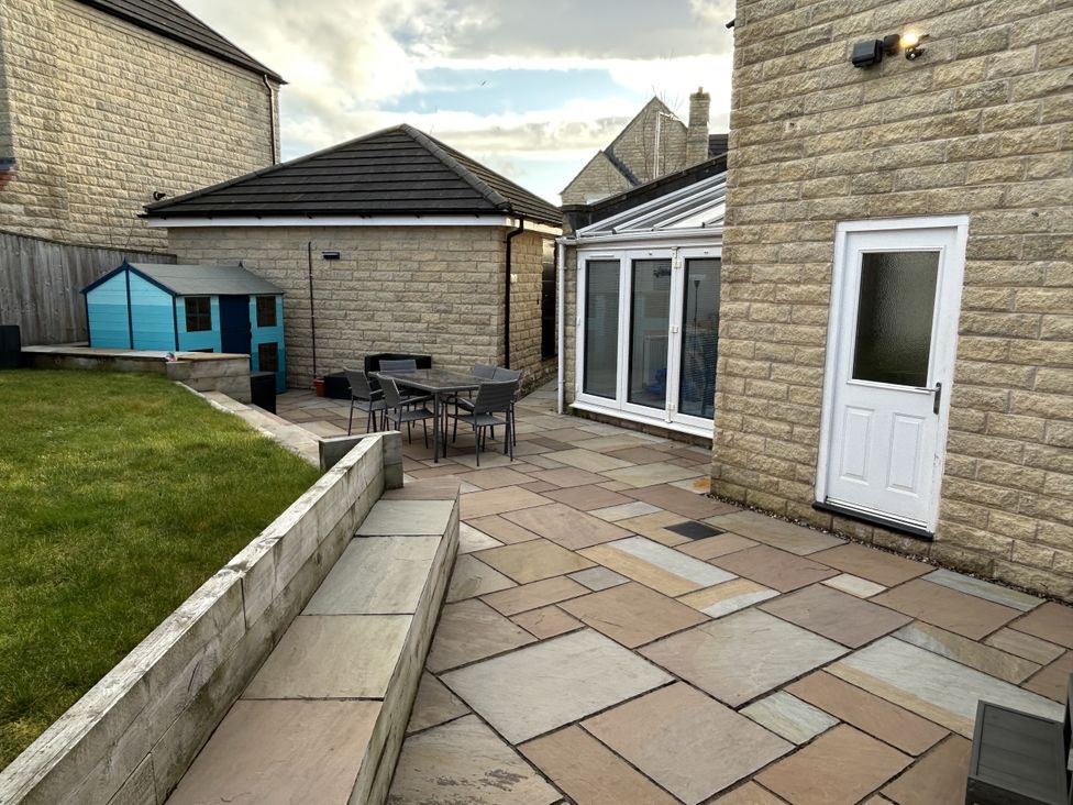A garden with a patio area and furniture at The Winster in Marple, Stockport