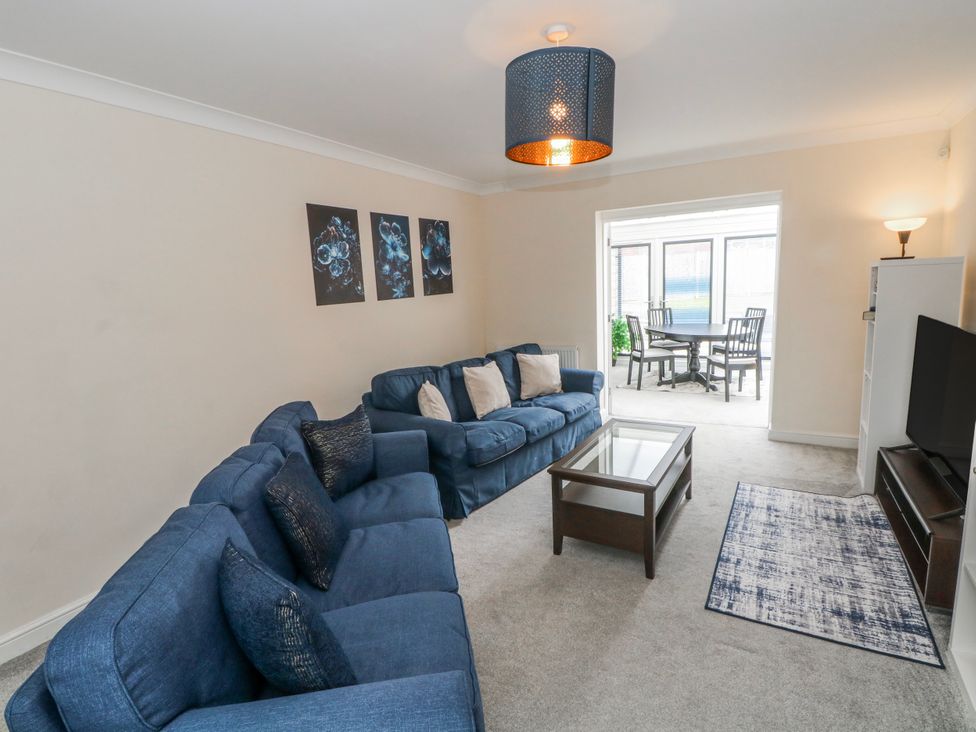 A living room with sofa coffee table and television at The Winster in Marple, Stockport