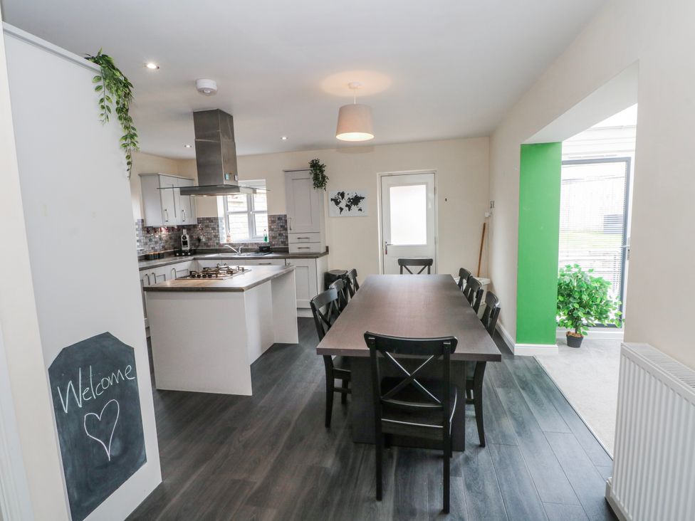 A dining room with a large table and chairs at The Winster in Marple, Stockport