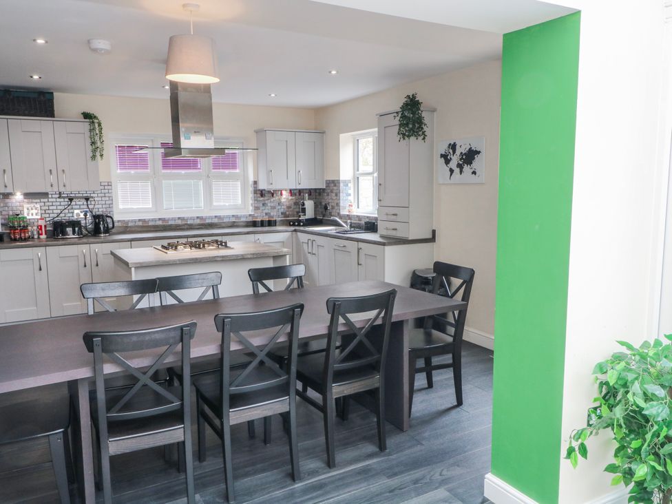 A kitchen with a dining table and chairs at The Winster in Marple, Stockport