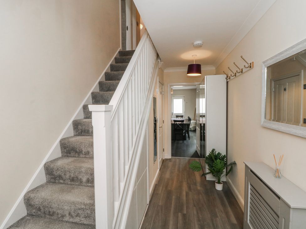 A hallway with a staircase and plants at The Winster in Marple, Stockport