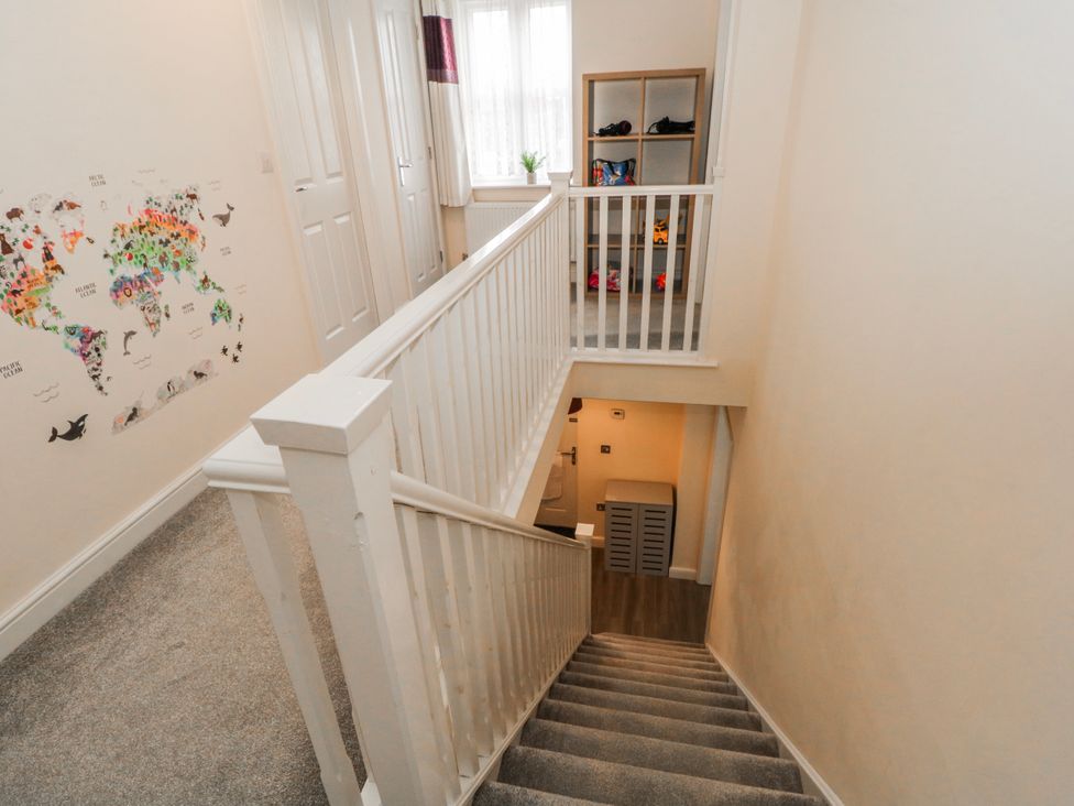 A staircase and shelf in a hallway at The Winster in Marple, Stockport