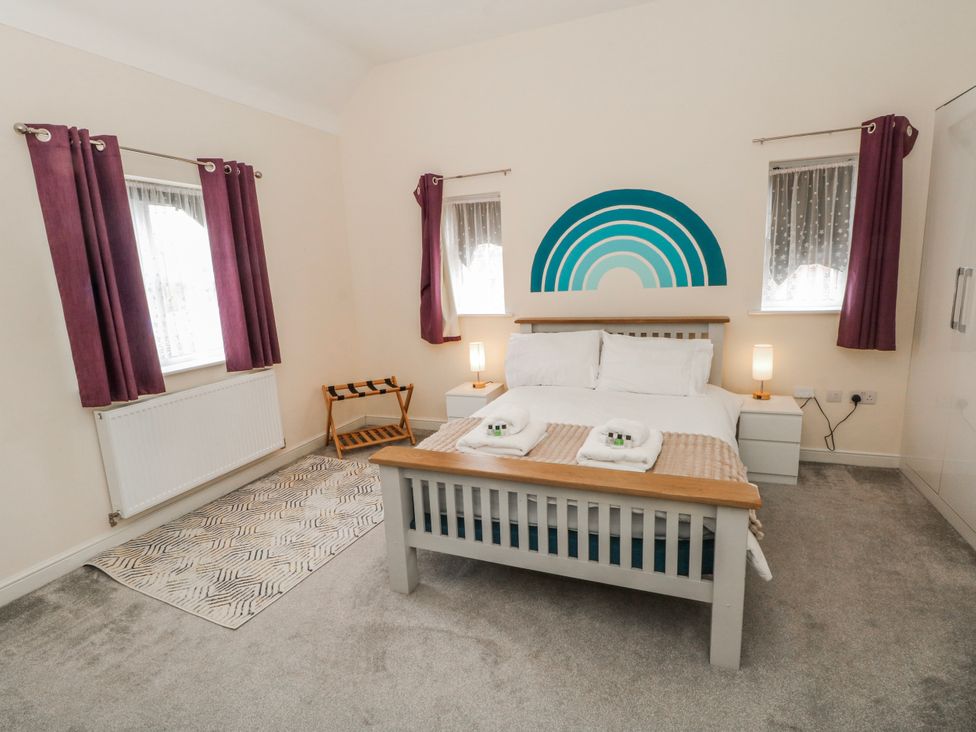 A bedroom with a bed and bedside table at The Winster in Marple, Stockport