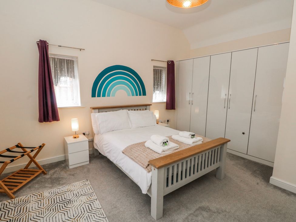 A bedroom with a bed and wardrobe at The Winster in Marple, Stockport