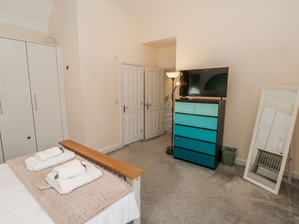 A bedroom with a bed and storage furniture at The Winster in Marple, Stockport