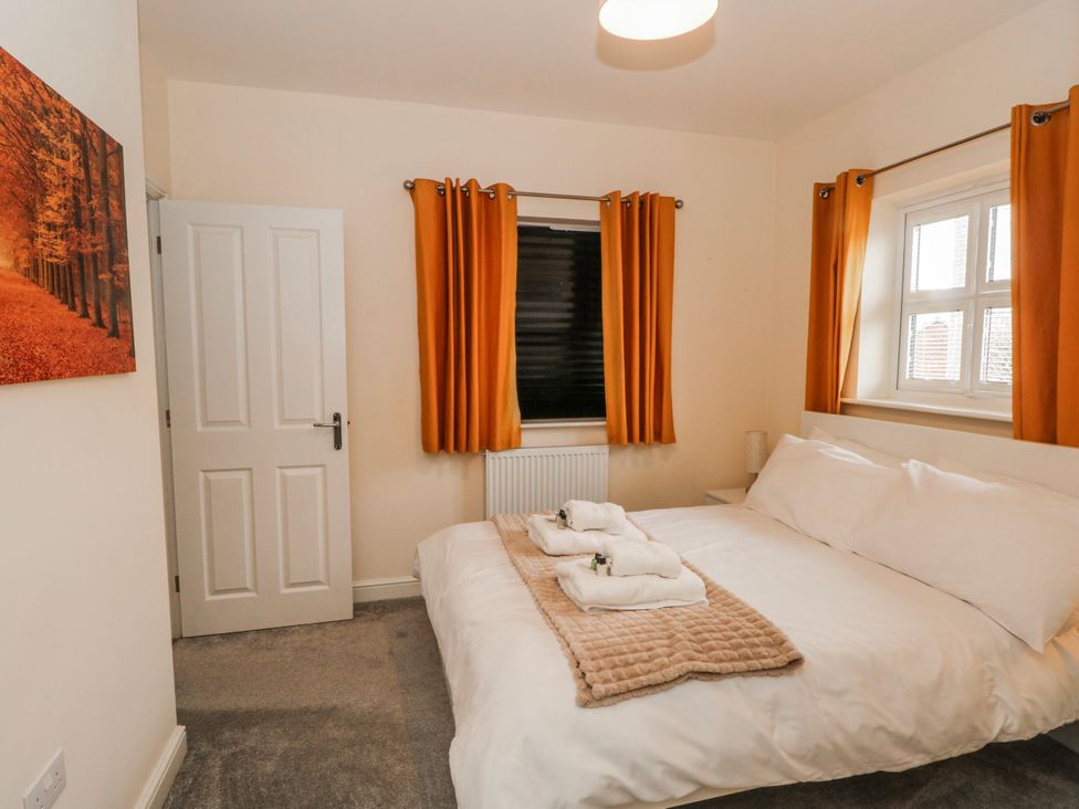 A bedroom with a bed and curtains at The Winster in Marple, Stockport