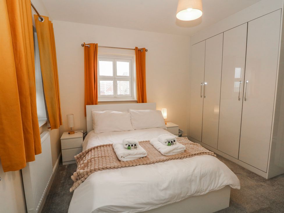 A bedroom with a bed and a wardrobe at The Winster in Marple, Stockport