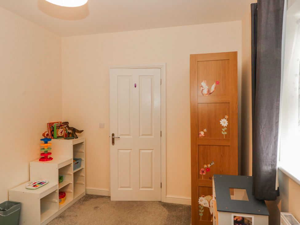 A children's room with a door and storage units at The Winster in Marple, Stockport