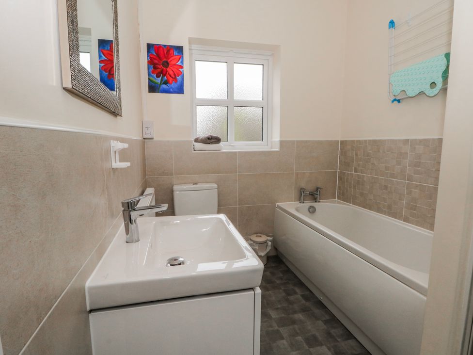 A bathroom with a sink, toilet, and bathtub at The Winster in Marple, Stockport