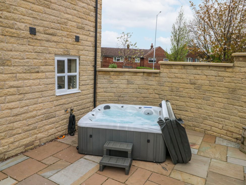 An outdoor area with a hot tub and a step at The Winster in Marple, Stockport