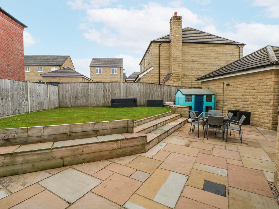 A garden with a patio and seating area at The Winster in Marple, Stockport