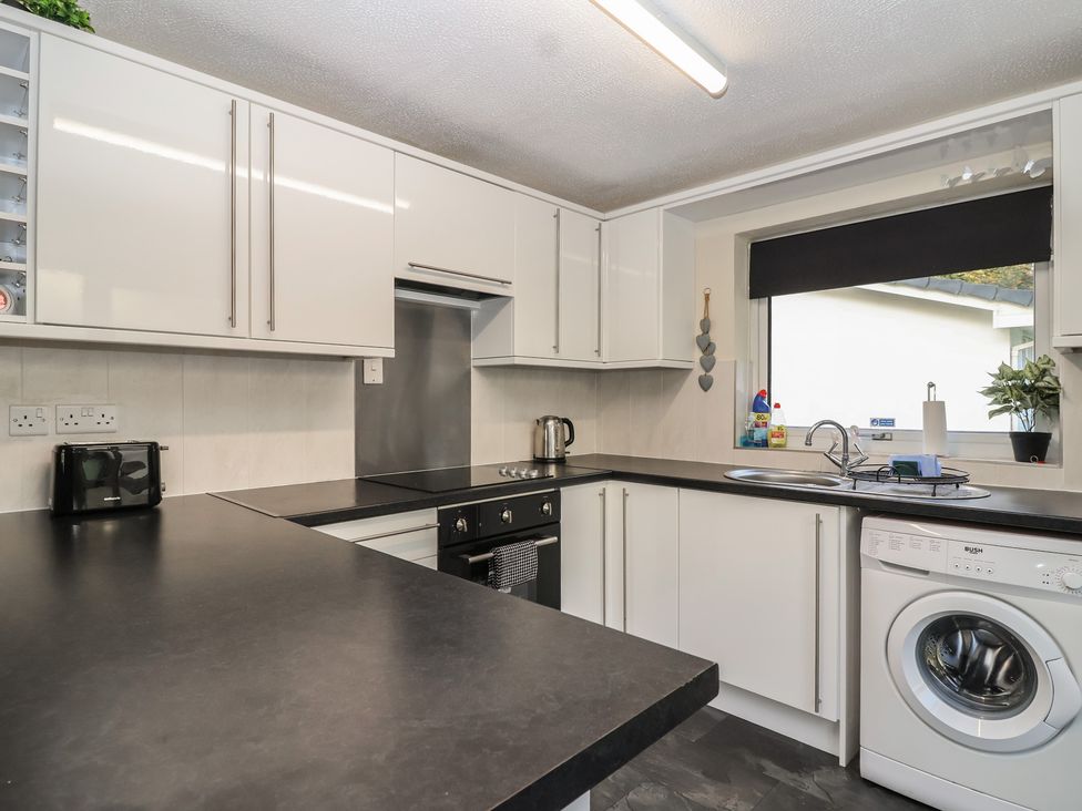 A kitchen with a sink and stove at Willow Lodge Rosecraddoc Lodge near Liskeard