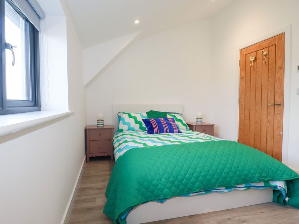 A bedroom with a bed and nightstand at Barn 5