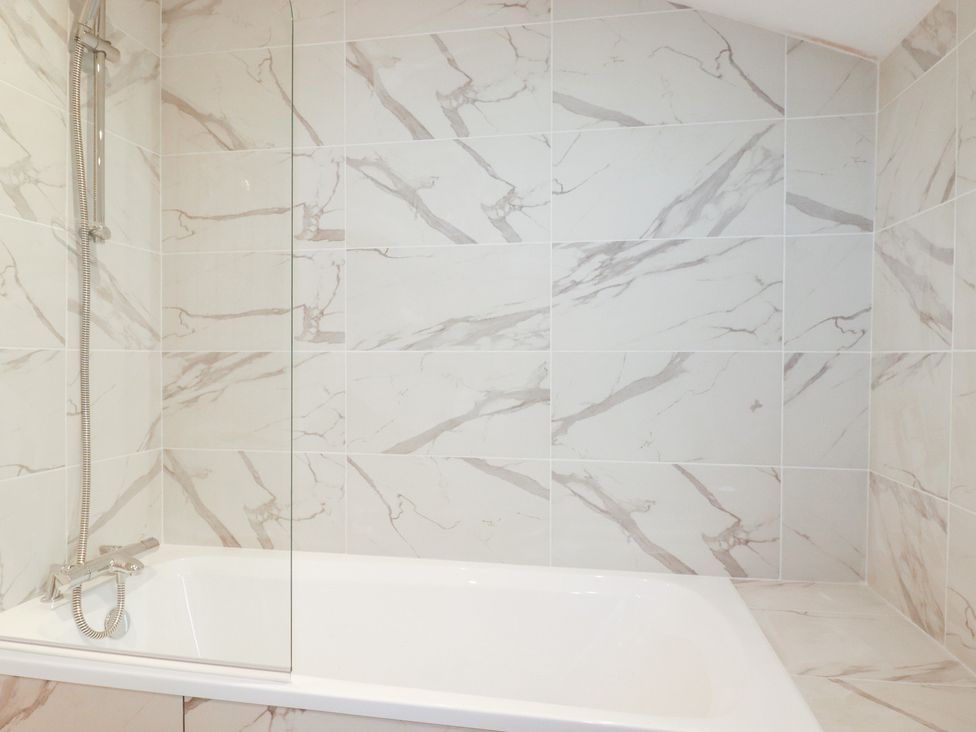 A bathroom featuring a bathtub and a shower at Barn 5