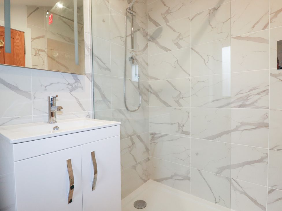 A bathroom with a shower and sink at Barn 5