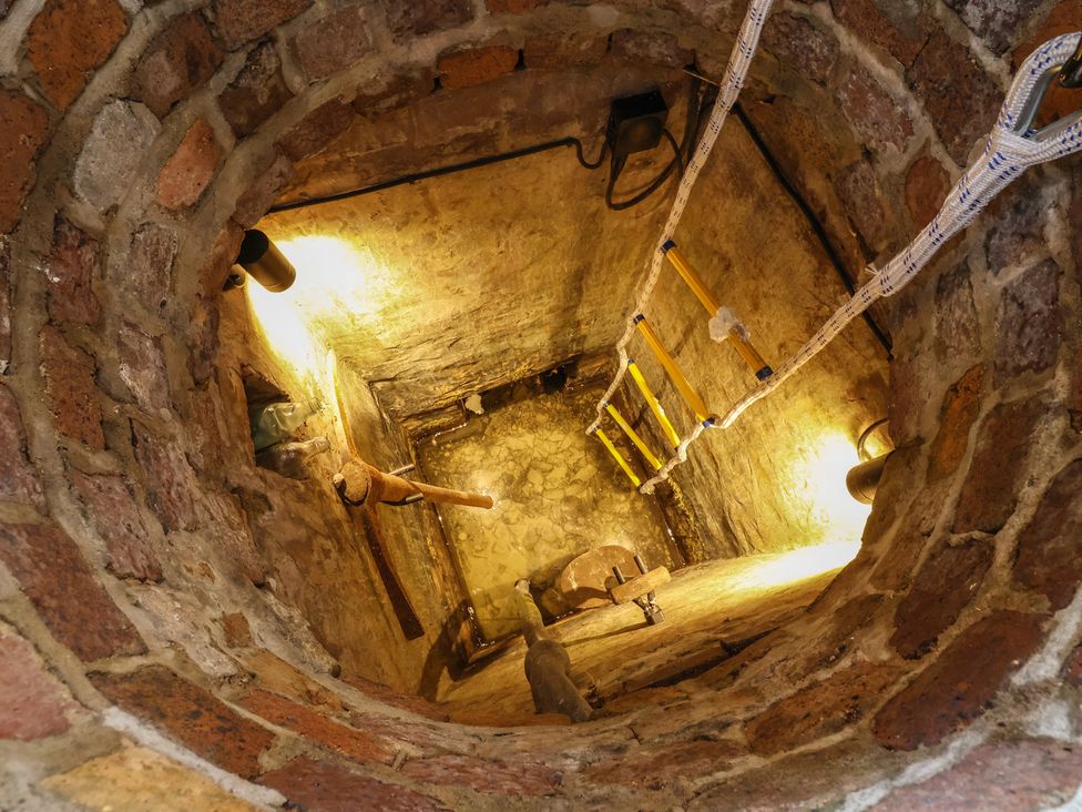 A view of a well with brick walls and a ladder at The Ranch in Prestatyn