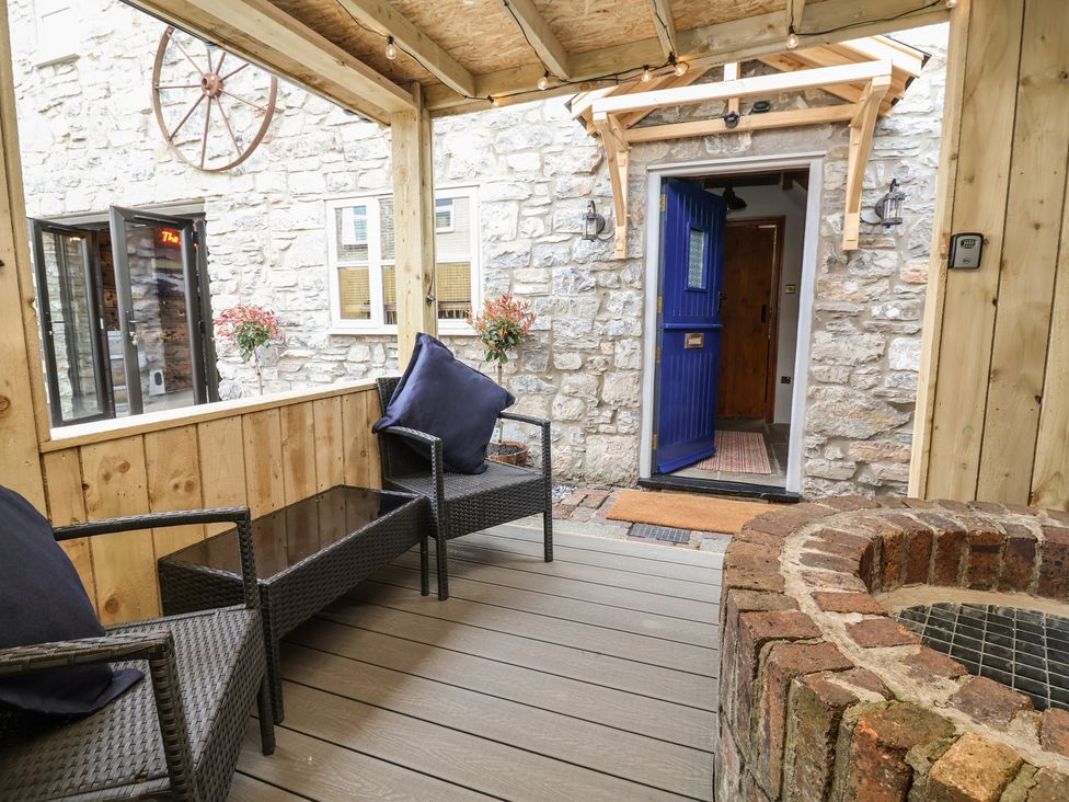 An outdoor seating area with a blue door and fire pit at The Ranch in Prestatyn